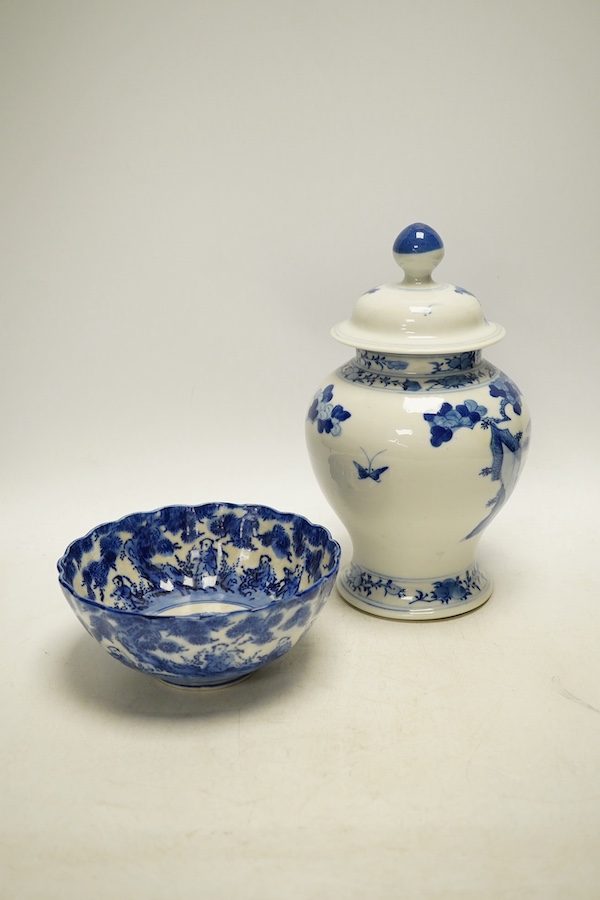 An early 20th century Chinese blue and white porcelain vase and cover decorated with figures in a landscape and a Japanese circular bowl, tallest 23cm. Condition - good